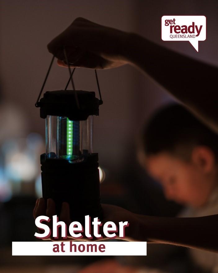 Image of hand holding a battery lamp in a dark room