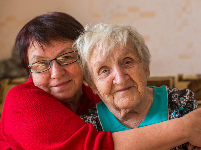 Elderly woman sitting with daughter